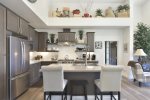 Gourmet Chefs Kitchen with Stainless Steel Appliances and Quarts Countertops